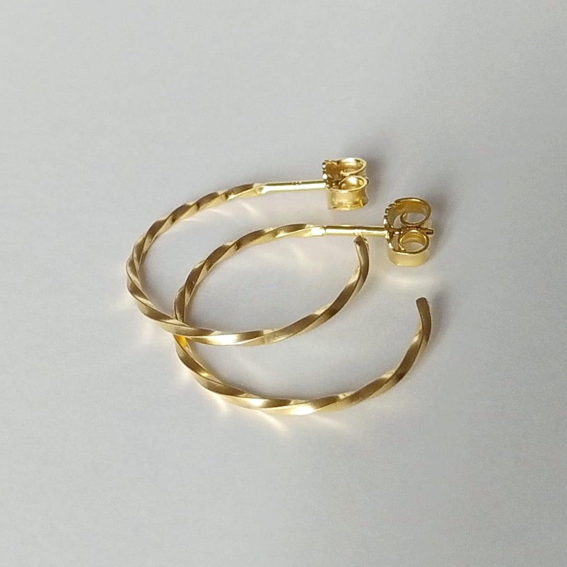 Carey | golden big twisted hoop ear studs